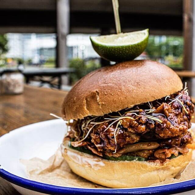 Korean fried chicken, kimchi and cucumber on a toasted brioche