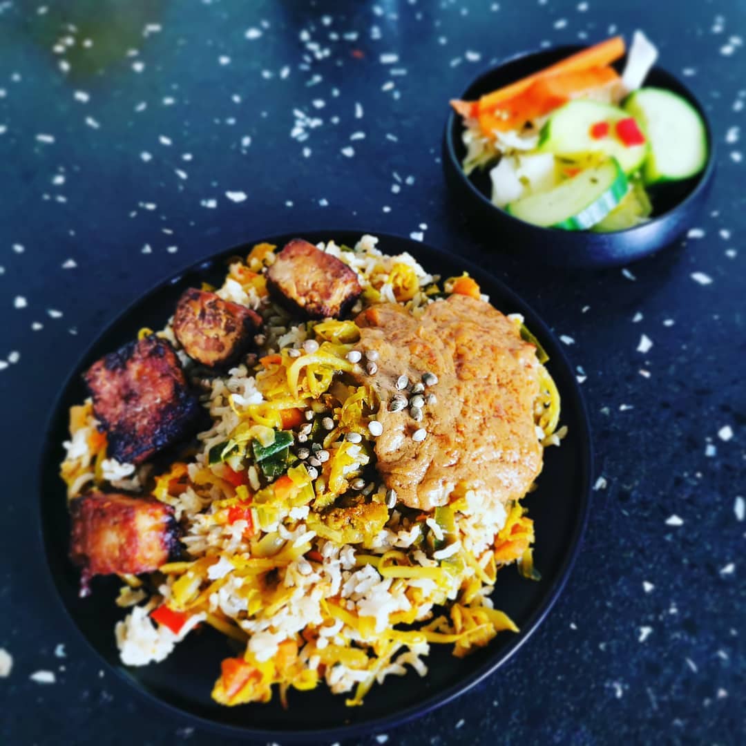 Nasi with veggies and spicy organic rice tempeh. Served with cucumber pickles